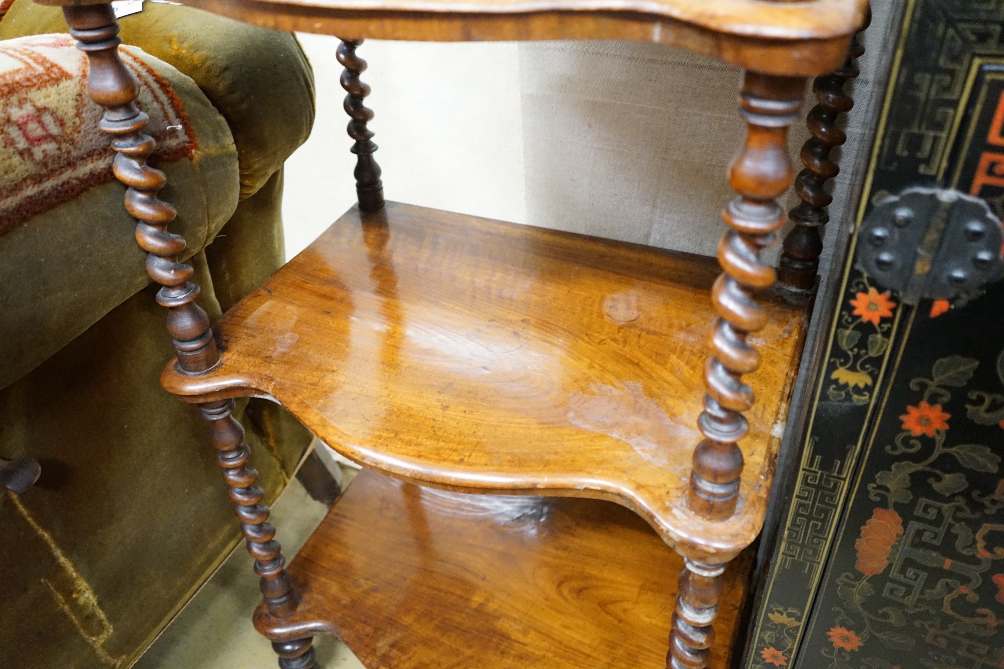 A Victorian walnut serpentine three tier whatnot, width 54cm, depth 38cm, height 104cm